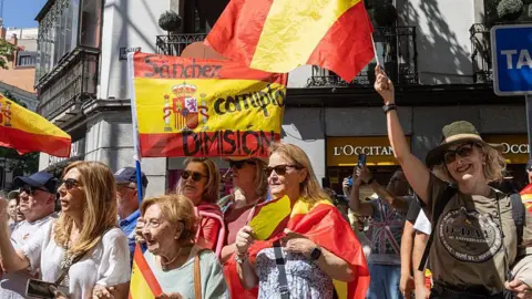 AFP via Getty Images Protesters march during a demonstration against Pedro Sanchez, Spain's prime minister, and the government, in Madrid, Spain, on Saturday, May 23, 2026