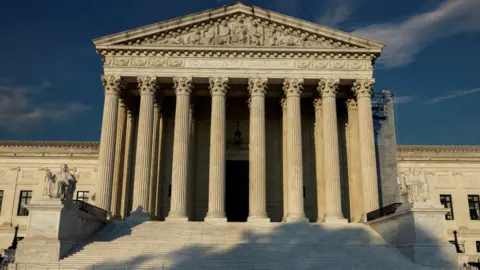 Reuters An exterior view of the US Supreme Court building's columned entrance in Washington DC with sunlight shining on it.