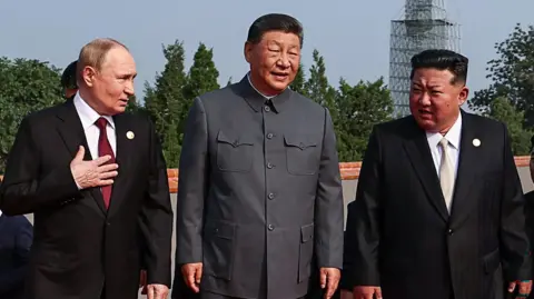 Getty Images Russia's President Vladimir Putin walks with China's President Xi Jinping and North Korea's leader Kim Jong Un during Xi's military parade in Beijing in 2025