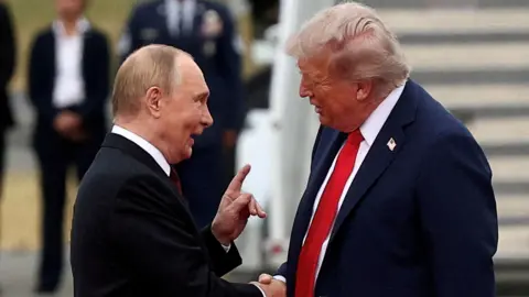Reuters/File photo President Putin and President Trump face one another and shake hands. They appear to be mid-conversation