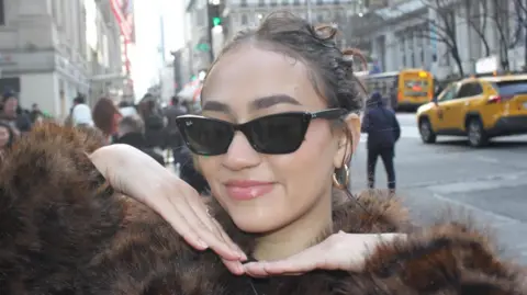 Kate Santos New York waitress Kate Santos wearing sunglasses and a furry jumper on a New York street