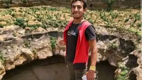 Yemen civil defence A photo of Al-Qaqa Ibn Antar standing next to a crater 