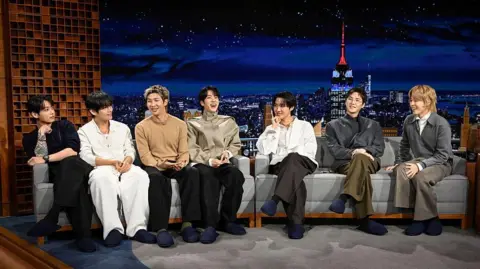 Getty Images Pictured: (L-R) Jung Kook, V, RM, Jin, j-hope, Suga, and Jimin of musical guest BTS during an interview on Wednesday, March 25, 2026 