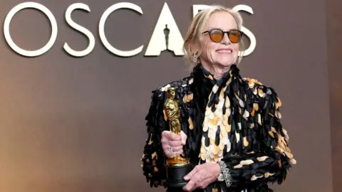 Getty Images Amy Madigan, winner of the Best Actress in a Supporting Role award for “Weapons”, poses in the press room during the 98th Oscars at Dolby Theatre on March 15, 2026 in Hollywood, California.
