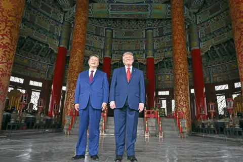 AFP via Getty Images China's President Xi Jinping (L) and US President Donald Trump visit the Temple of Heaven in Beijing on May 14, 2026. Xi warned Trump that the issue of Taiwan could push their two countries into "conflict" if mishandled, a stark opening salvo as a superpower summit set to tackle numerous thorny issues began in Beijing on May 14 2026