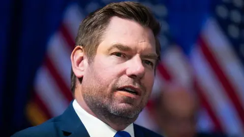 Getty Images Rep. Eric Swalwell, D-Calif., speaks during the House Democrats hearing marking the five year anniversary of the attack on the Capitol, in the Capitol Visitor Center on Tuesday, January 6, 2026. 