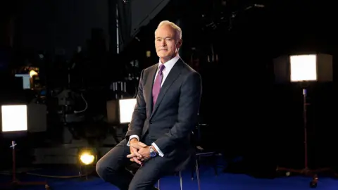 Getty Images Scott Pelley sits in a chair posing for a portrait 