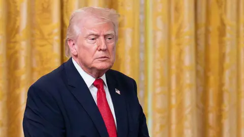 Getty Trump in red tie and suit blazer against gold curtain