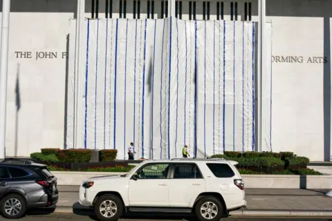 Reuters Long white and blue plastic sheeting over the Kennedy Center