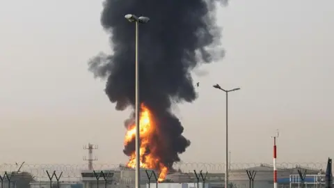 Shutterstock Smoke rises from an area near Dubai International Airport in Dubai, following what the United Araba Emirates says was a "drone incident". Photo: 16 March 2026