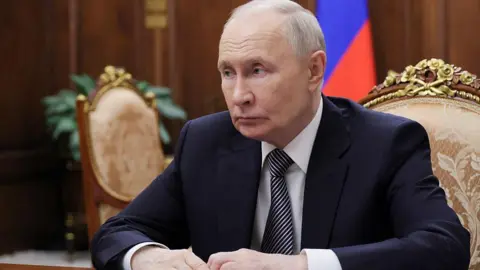 AFP via Getty Images In this pool photograph distributed by the Russian state agency Sputnik, Russia's President Vladimir Putin looks on as he attends a meeting with the Head of the Tyva Republic in Moscow on May 22, 2026