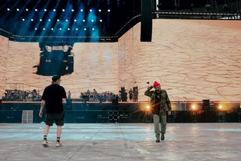 Blair Brown Gorillaz co-creators Damon Albarn (right) and Jamie Hewlett put the finishing touches to the band's first ever stadium show in Tottenham Hotspur Stadium.