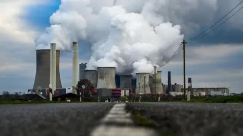 AFP via Getty Images Vapour billowing from the cooling towers of the Niederaussem power station in Germany, which burns cheap, lignite coal