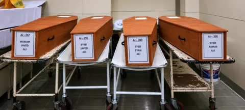 Imtiyaz Ali The coffins of Javed, Mariam and their two children, kept on hospital stretchers in Ahmedabad. 