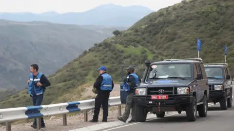 Reuters Observers of the European Union stand next to their cars on a road near the Armenia-Azerbaijan border and Nagorno Karabakh region outside the village of Kornidzor, Armenia