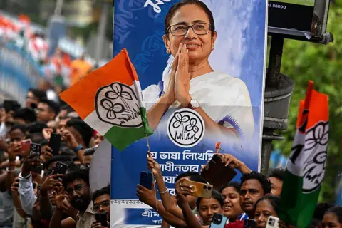 AFP via Getty Images Supporters of the All India Trinamool Congress party attend a rally of Chief Minister of West Bengal Mamata Banerjee ahead of the second phase of the legislative assembly elections in Kolkata on April 27, 2026.