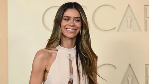 Getty Images Tiktok star Taylor Frankie Paul attends the 98th Oscars on 15 March in a cream gown.