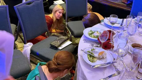 Reuters Guests take cover near a table after hearing shots at the White House Correspondents' Association dinner at the Washington Hilton hotel in Washington.