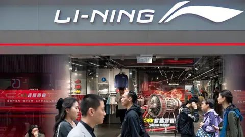 Getty Images People walking in front of a Li-Ning store in China