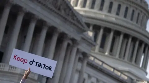 Getty Images A person holds a sign during a press conference about their opposition to a TikTok ban on Capitol Hill in Washington, DC on March 22, 2023.