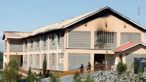 Reuters A two-storey dormitory building. Burn marks can be seen coming up on the external walls of the first floor.