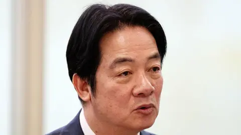 Bloomberg via Getty Images Close-up of Lai Ching-te wearing a suit, with his lips pursed