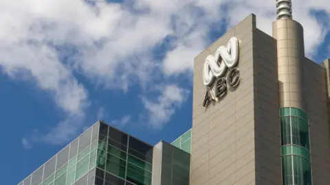 Getty Images ABC Australia's building and logo against a blue sky background with some white clouds