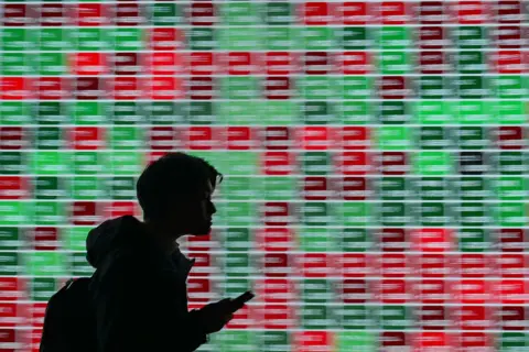 Bloomberg via Getty Images An electronic board displays stock figures outside a securities firm in Tokyo, Japan, on Tuesday, Jan. 28, 2025. 