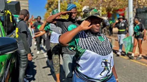 Tebogo Letsie/Getty Images MK members salute outside the Constitutional Court in Johannesburg, South Africa - Friday 10 May 2024