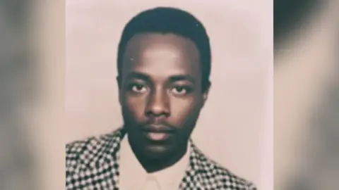 Biniam Solomon An old passport photo of Biniam Solomon, He is wearing a dog-tooth jacket and white shirt.