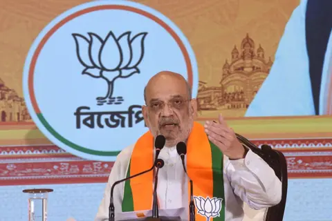 NurPhoto via Getty Images Union Home Minister Amit Shah reacts during a ''Meet the Press'' interaction after releasing the Bharatiya Janata Party's 'Sankalp Patra' for the 2026 West Bengal Assembly elections in Kolkata, India, on April 10, 2026.via Getty Images)