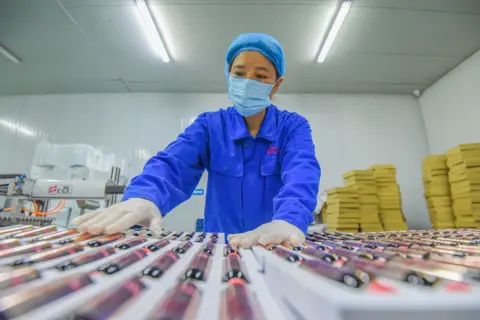 Huang Zhigang/VCG via Getty Images A worker inspects bioactive peptides at a workshop of Hubei Reborn Biotech Co., Ltd on November 17, 2020 in Jingzhou, Hubei Province of China.