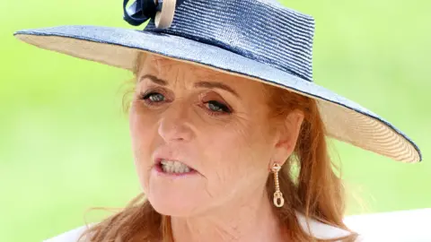Getty Images Sarah Ferguson Duchess of York attends day two of Royal Ascot 2024 at Ascot Racecourse on June 19, 2024 in Ascot, England, wearing a white and blue sun hat and gold earrings
