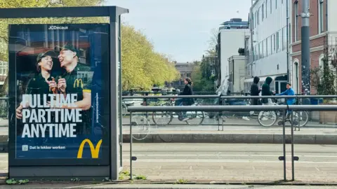 BBC An advert for McDonald's on a bridge in the centre of Amsterdam