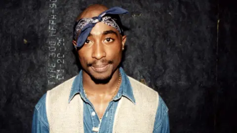 Getty Images Tupac Shakur poses for photos backstage after his performance at the Regal Theater in Chicago, Illinois in March 1994. 