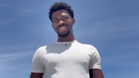 Lil Nas X/Instagram Lil Nas X pictured in a white t-shirt against a clear blue sky, in a screengrab from his Instagram statement