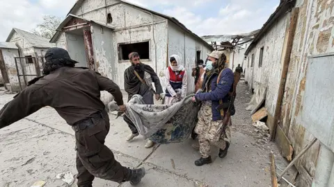 Anadolu via Getty Images Bodies are removed following reported Pakistani airstrikes in Kabul, Afghanistan on March 17, 2026. Afghan officials said the strikes allegedly hit a drug rehabilitation centre in the capital, causing civilian casualties. 