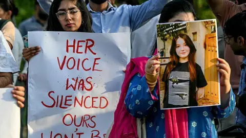 Getty Images Women activists holding posters and photographs of TikTok influencer Sana Yousaf in a demonstration after she was murdered