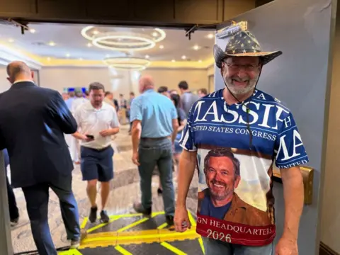 Getty Images Man wearing cowboy hat and T-shirt saying MASSIE /UNITED STATE CONGRESS