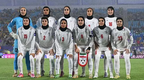Getty Images Islamic Republic of Iran players line up for a team photo prior to the AFC Women's Asian Cup Australia 2026 match on March 05