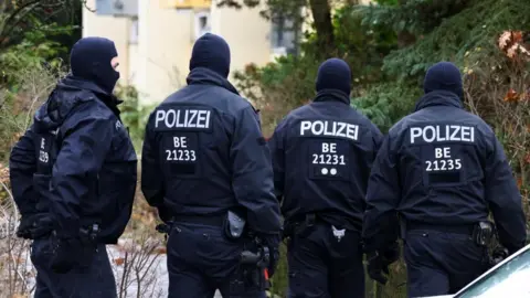 Reuters Police in balaclavas and dark coloured uniforms