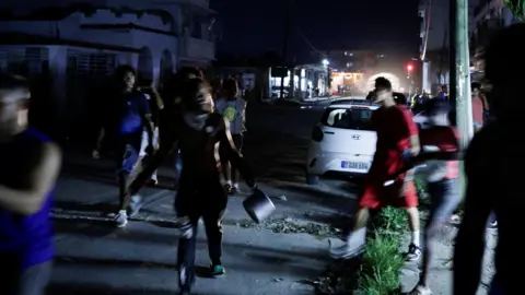 Reuters Dozens of protesters carrying pots and pans run through the streets of Havana at night in protest of recent energy shortages.