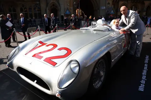 Bryn Lennon/Getty Images Elliot Moss with his daughter Stephanie pose beside vintage race car in London