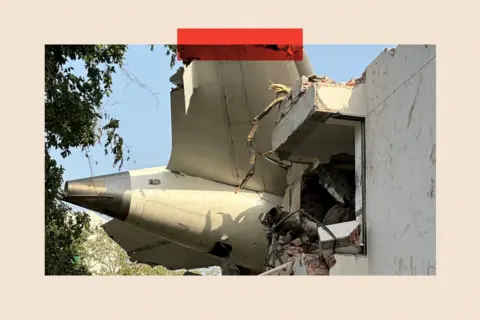 Reuters The tail of the aircraft through the edge of a building