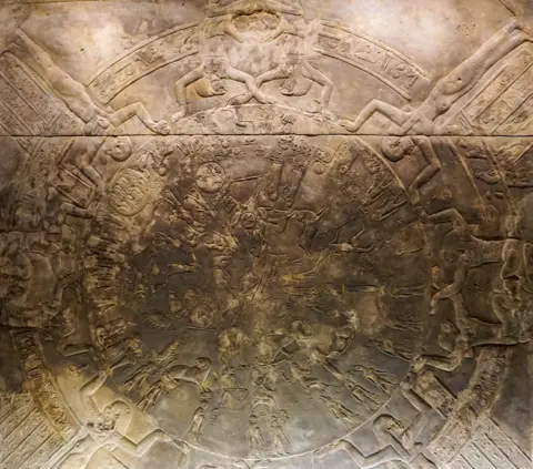 Getty Images Close-up of the Dendera Zodiac. Engravings of Ancient Egyptian gods and goddesses, animals and hieroglyphics organised in the circle. The engraved material was likely originally white but is greying with age. The figures on the circle represent various constellations and celestial bodies. 
