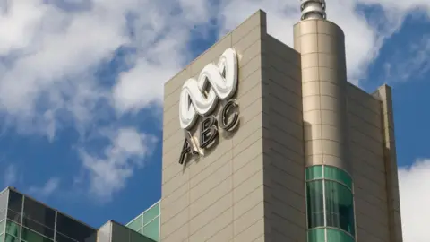 Getty Images ABC Australia's building and logo against a blue sky background with some white clouds