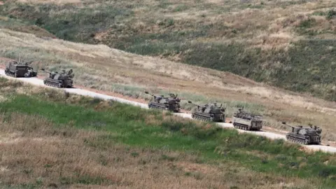 Reuters Israeli self-propelled artillery move into southern Lebanon after crossing the Israeli border, as seen from northern Israel (27 May 2026)