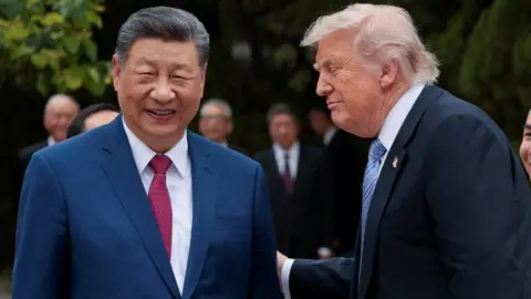 Reuters Chinese President Xi Jinping (L) smiles facing the camera while US President Donald Trump (R), facing towards him, also smiles, after the two leaders visited the Zhongnanhai Garden in Beijing.