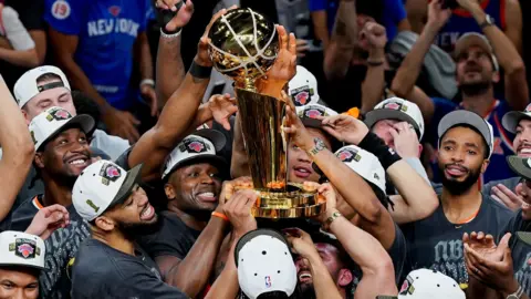 Dustin Safranek-Imagn Images TPX IMAGES OF THE DAY The New York Knicks hoist the trophy after defeating the San Antonio Spurs in game five of the 2026 NBA Finals to win the 2026 NBA Championship at Frost Bank Center. 