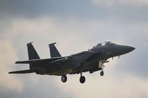 Getty Images A USAF F15 Eagle aircraft in the air, coming in to land at RAF Lakenheath, UK, in July 2025